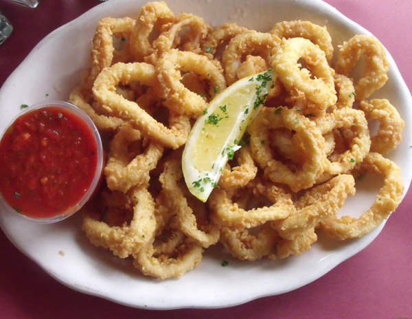 Fried Calamari appetizer at Mama Leones Calamari rings lightly battered and fried golden brown served with marinara sauce.